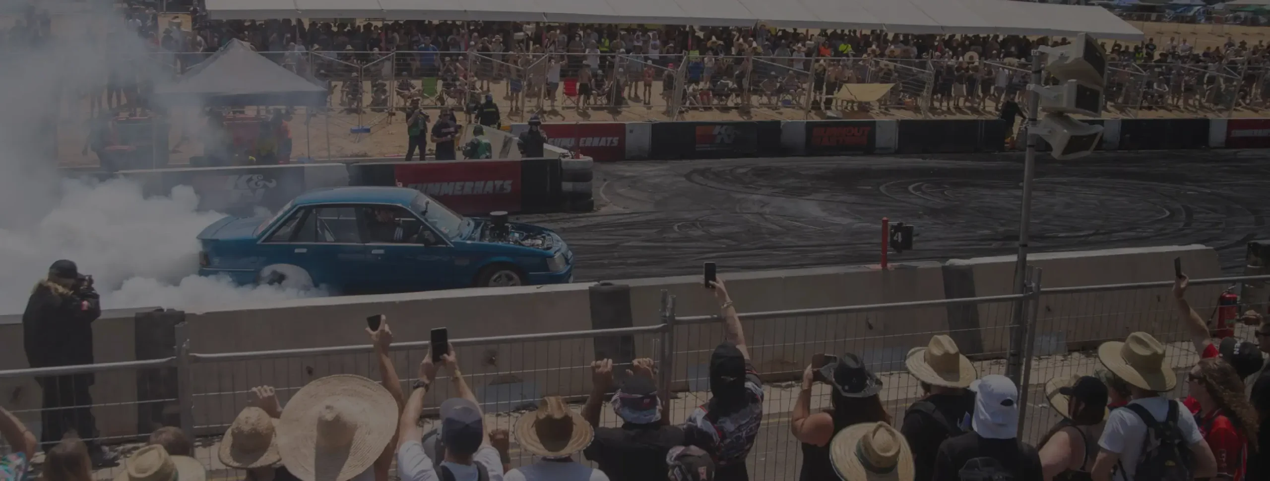 DBA brake performance demonstrated in motorsport racing with spectators watching car performing burnout on track