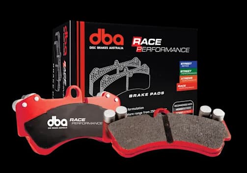 DBA Race Performance brake pads with red backing plates and specialized friction material alongside retail packaging box