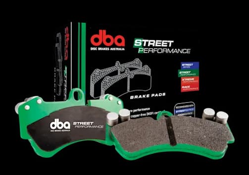 DBA Street Performance brake pads with green backing plates and friction material displayed alongside retail packaging box